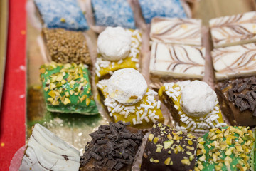 horizontal image with a close-up detail of typical Moroccan pastries of various kinds served on a tray
