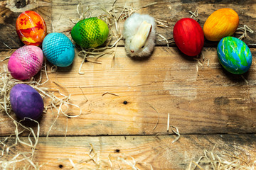 beautiful, bright, very colorful hand-painted eggs on a contrasting, raw, natural background from wooden planks