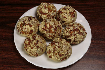 Traditional oriental ginger cookies on the wooden table.  Gingerbread with nuts, almonds, sage and saffron.