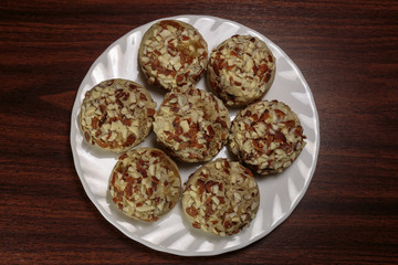 Traditional oriental ginger cookies on the wooden table.  Gingerbread with nuts, almonds, sage and saffron.