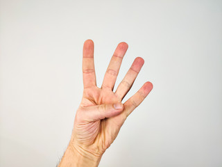 left hand showing four fingers