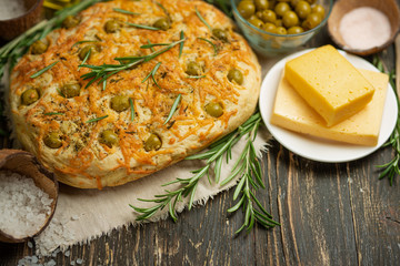 Traditional Italian focaccia with green olives and rosemary - homemade flat bread flatbread