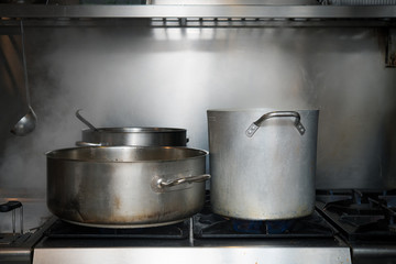 Restaurant kitchen interior gas stove and pots