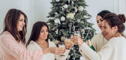 Portrait of four beautiful young girls is in Christmas sceneries