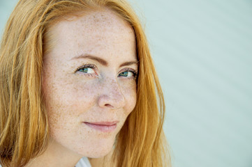 Young girl with red hair and freckles.