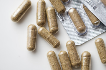 Biologically active food supplements in capsule on a  light background, macro