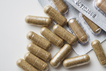 Biologically active food supplements in capsule on a  light background, macro