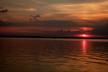 Naklejka na ściany i meble Beautiful summer sunset in the lake Svityaz. Sunset Background