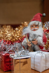 Père Noël entouré de cadeaux de Noël et de guirlandes de noël