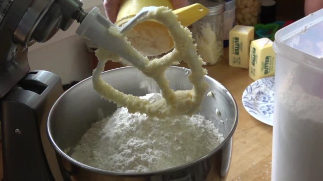 Adding flour to a mixer for cookie recipe in slow motion