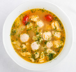 Soup with turkey meatballs. On a white background