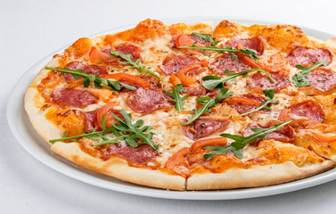 Pizza with salami and bell peppers. On a white background