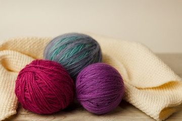 Balls of thread for knitting on a wooden background