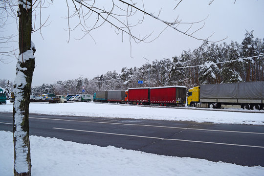 Fototapeta View of the winter city and trucks in the distance near the forest in winter.