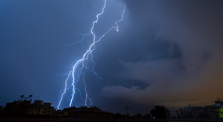 Lightning falling over the city at night