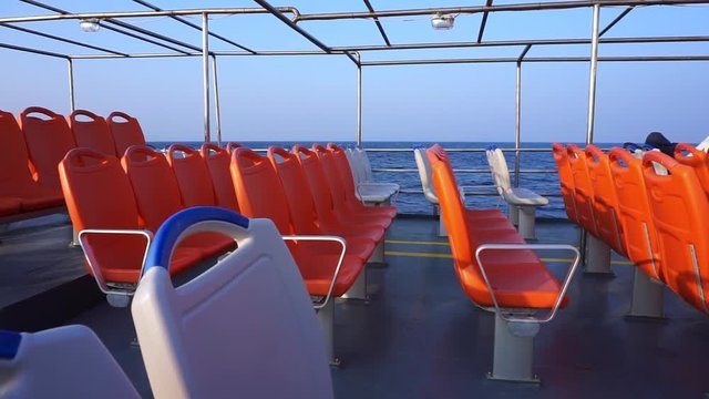 Empty seats on a ferry boat deck sailing on Mediterranean Sea