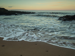 waves breaking on the inshore rocks at Croyde beach in North Devon