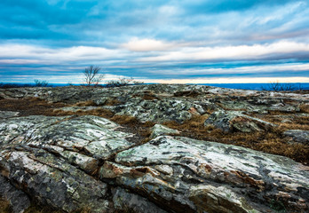 Rocky granite outcroppings under a beautiful blue cloudy sky at dusk, High Point Monument at the...
