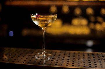 Elegant glass filled with tasty sweet drink decorated with rose bud