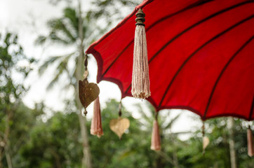 Traditional asian red umbrella with pompoms