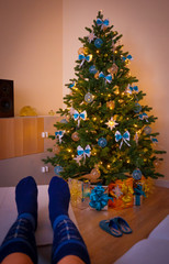 Christmas. Christmas tree, decorated gift box, woman legs