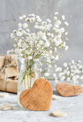 Bouquet of small white flowers and wooden hearts