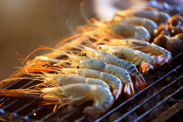 Fresh grilled river shrimp on the grill with flames