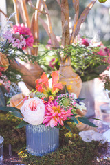 Fototapeta premium pink florals arranged in metal vase with peat moss