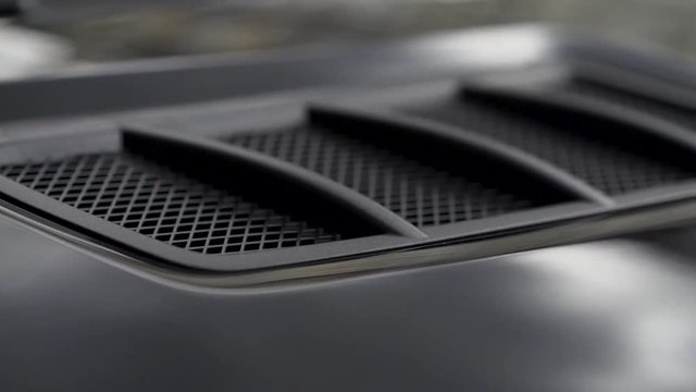 Air intake in the carbon hood of sport car. Stock. Luxury car exterior details.
