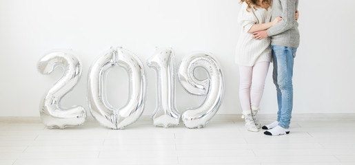 New 2019 Year is coming concept - Close up of romantic young man and woman with silver colored numbers on white background