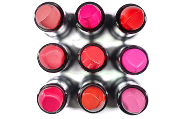 Lipstick of different colors isolated on white background