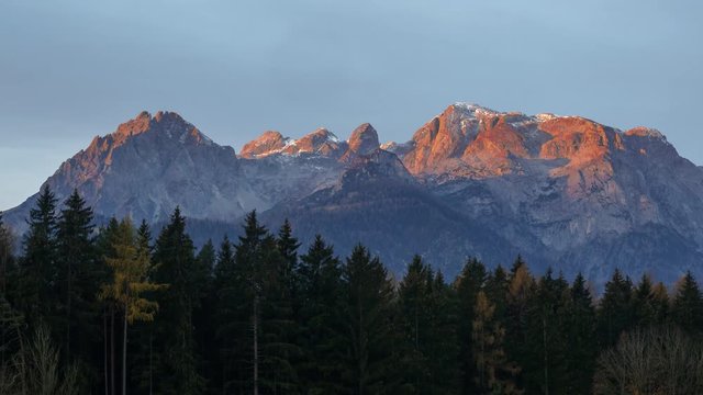 TL timelapse of sunrise at the Hochkoenig Mountains in Salzburg, mountains glow in orange sunlight