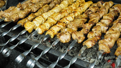 BBQ juicy chicken meat on skewers is prepared on the coals in the kitchen of restaurant
