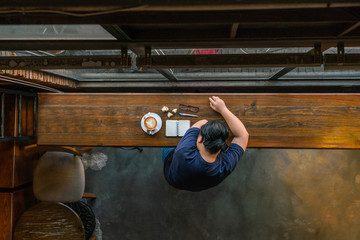 Top view of young Asian freelancer sleeping after working hard
