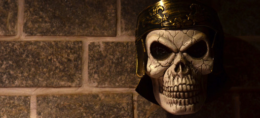 Skull of a Roman soldier with centurion helmet pinned to the wall