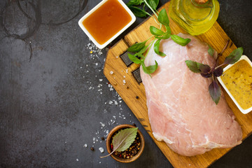 Raw meat and marinade Ingredients - honey, olive oil and mustard. Preparation meat for baking. Top view flat lay background. Copy space.