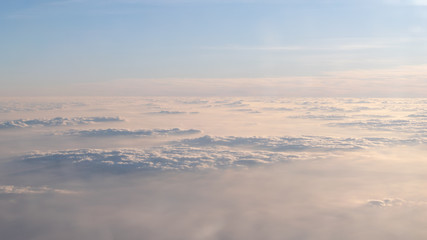 Image of Sunrise above the clouds from airplane window, India