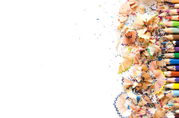 Drawing tools background. Lot of colorful pencils frame with sawdust and shavings on white, copy space, flat lay