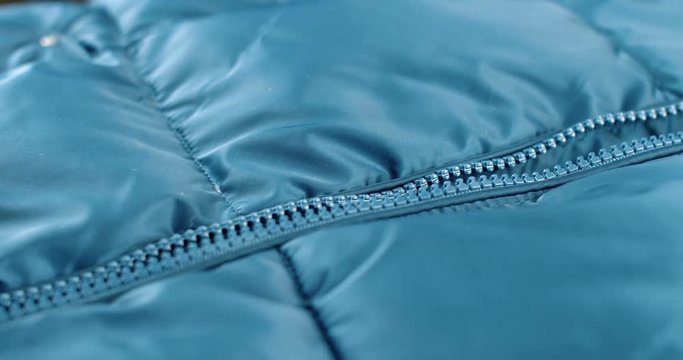 Modern close up of zipper on blue fashion clothes. 4K footage.