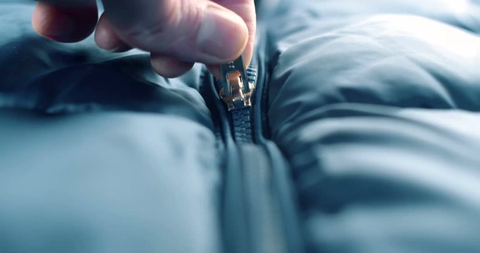 Modern close up of zipper on blue fashion clothes. 4K footage.