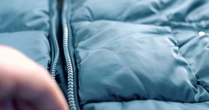Modern close up of zipper on blue fashion clothes. 4K footage.