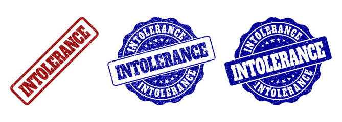INTOLERANCE grunge stamp seals in red and blue colors. Vector INTOLERANCE signs with grunge effect. Graphic elements are rounded rectangles, rosettes, circles and text captions.