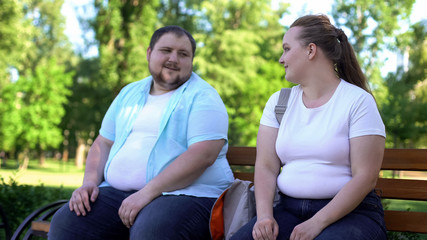 Erudite obese man telling interesting stories to pretty girl, self-confidence