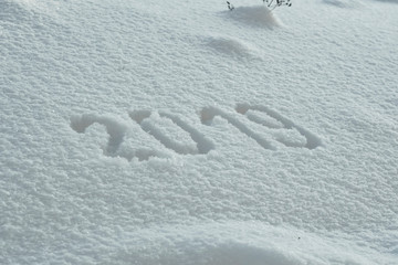 abstract winter New Year's and Christmas background from snow.text on snow 2019