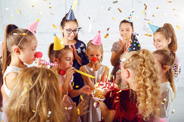 Obraz premium Children with a birthday cake have fun.