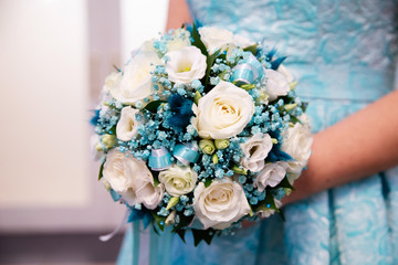 Wedding bouquet of flowers in the hands of the bride