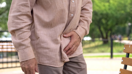Elderly man suffering from prostate inflammation, sudden pain, mens health