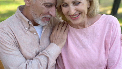 Married couple enjoying outdoor date, laughing together, relation closeness