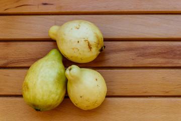 Whole guava fruits on wooden table