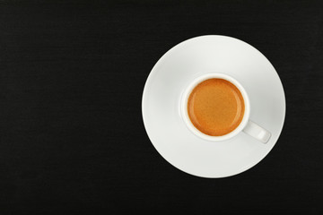 Full white espresso coffee cup over black